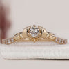 Round diamond ring featuring a traditional Claddagh design crafted in yellow gold.