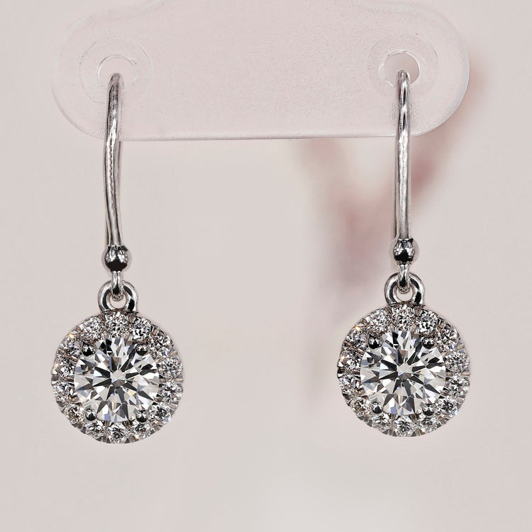 Elegant halo diamond earrings with a sparkling finish.
