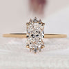 Elongated radiant cut diamond ring with round side diamonds.
