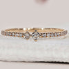 Half eternity wedding band in yellow gold with round cut diamonds.
