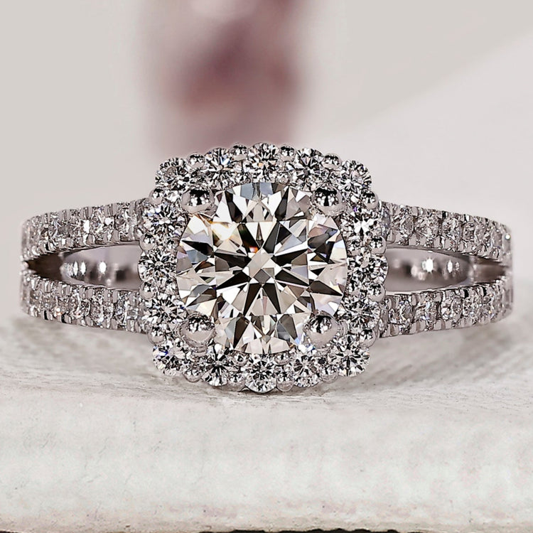 Round diamond engagement ring with halo setting.
