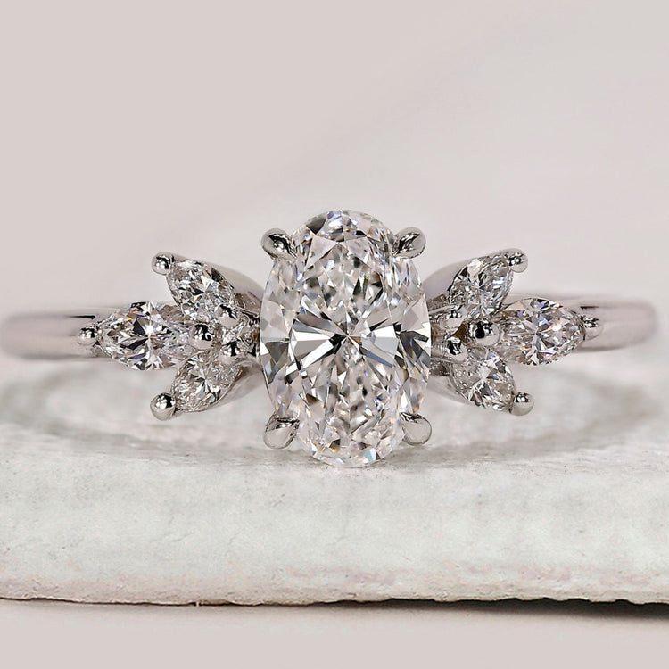 Oval cut diamond ring with marquise side stones.
