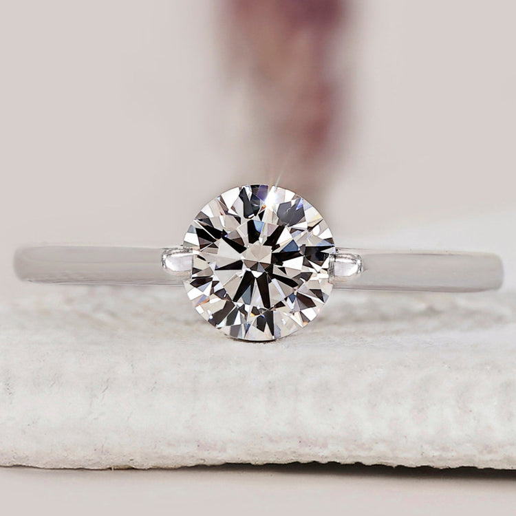 Round solitaire engagement ring with a classic design.

