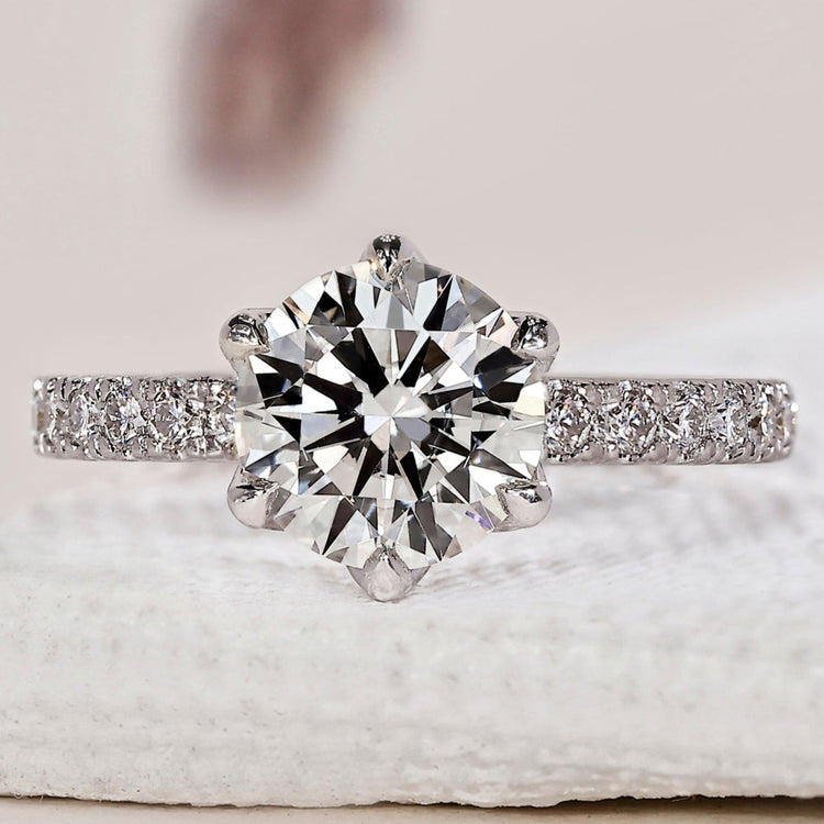 Tulip setting engagement ring with a round diamond.
