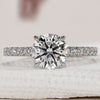 Hidden halo ring with round cut diamond and pave design.
