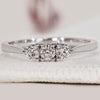 3 stone band featuring round diamonds set in white gold.
