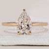 Pear solitaire engagement ring in yellow gold.

