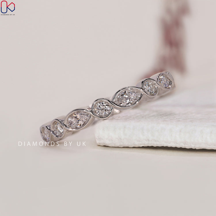 White gold diamond wedding band with a perfect marquise diamond setting.
