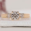 Three Stone Round Diamond Ring with two round side diamonds in a prong setting.

