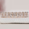 Radiant cut diamond band in a half eternity style set in yellow gold.
