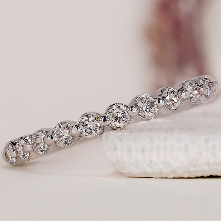 An elegant handmade half eternity diamond wedding band featuring sparkling round diamonds.
