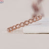 Handmade jewelry featuring a rose gold eternity band with diamonds.
