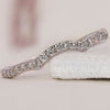 Elegant curved diamond wedding band featuring a timeless design.
