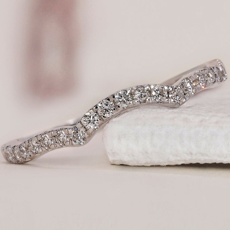 Elegant curved diamond wedding band featuring a timeless design.
