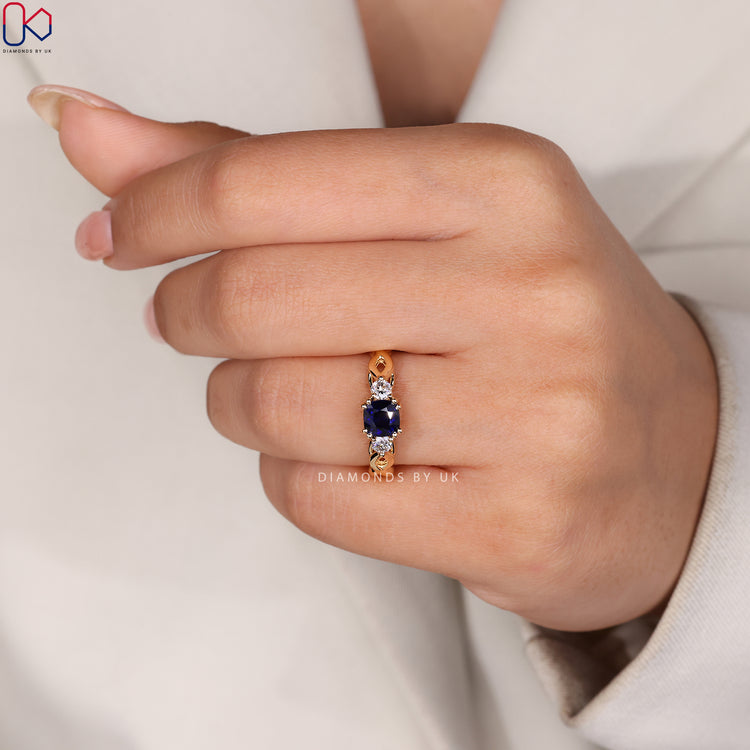 Custom diamond and sapphire ring handcrafted in yellow gold.
