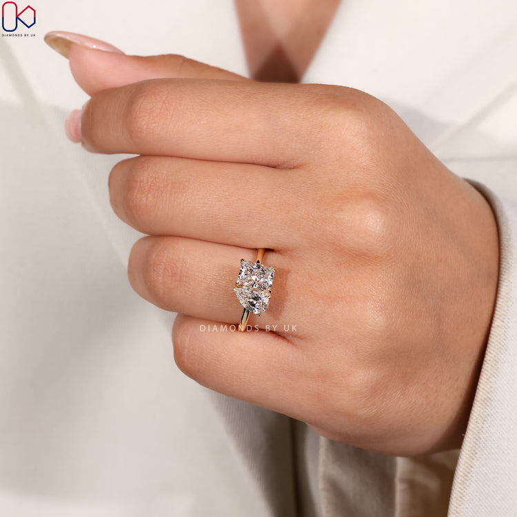 Radiant cut diamond ring with a unique design.
