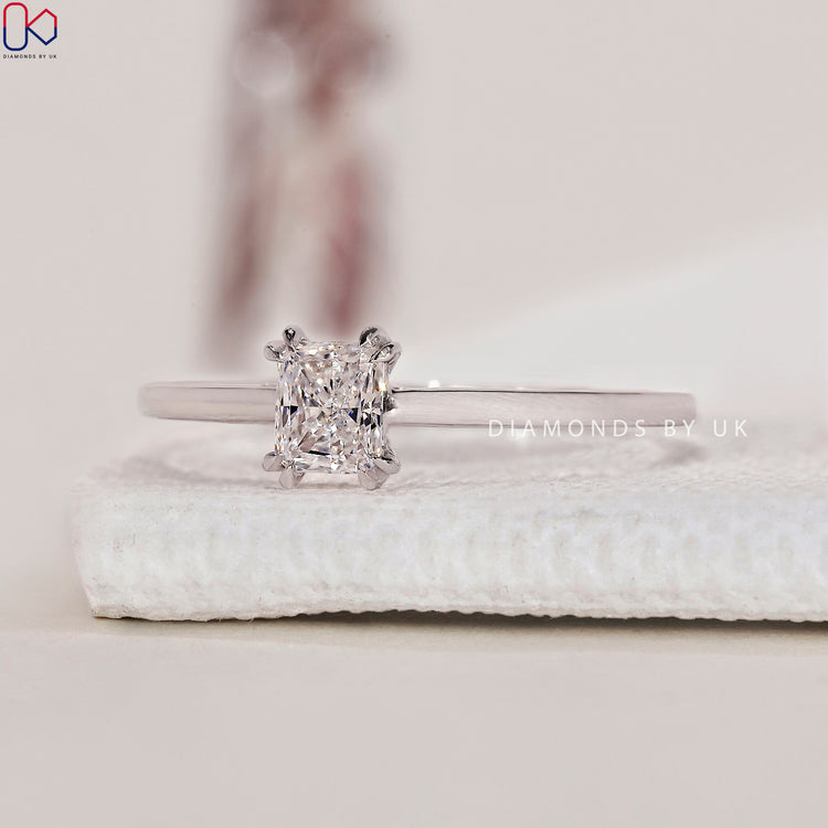 White gold ring with a radiant cut ring centre for timeless elegance.
