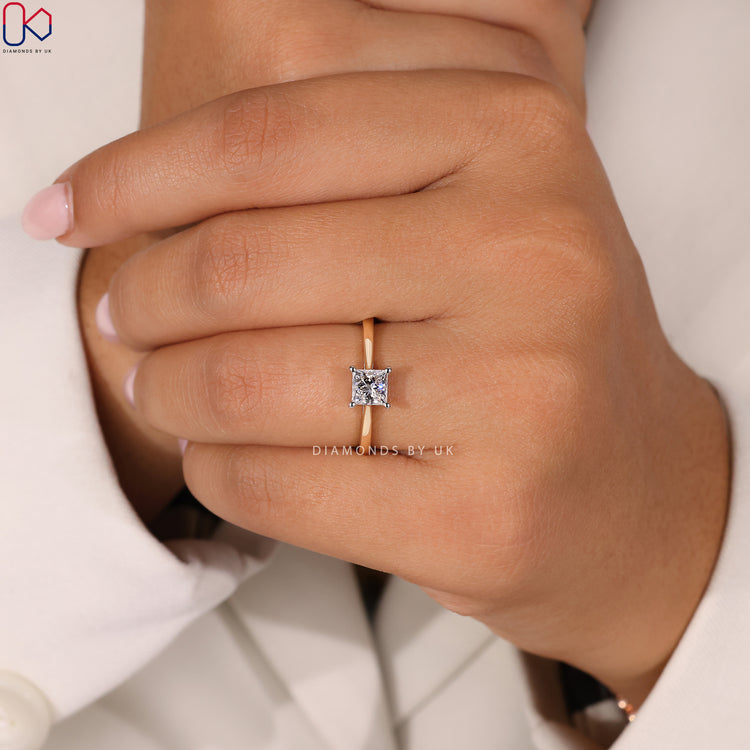 Elegant princess cut diamond ring in a 2 tone setting.
