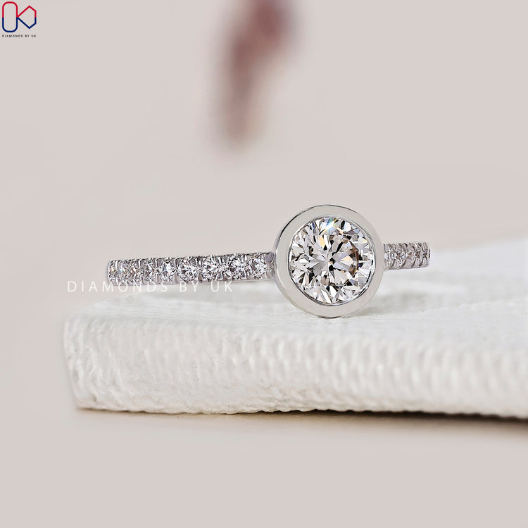 Customise your bezel round diamond ring in white gold.
