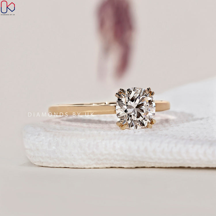 Double claw prong setting holding a round cut ring with secure and brilliant diamond placement.