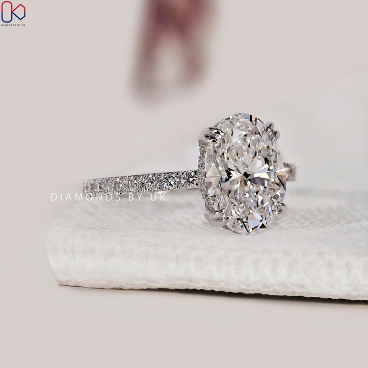 Double claw prong setting with an oval diamond.
