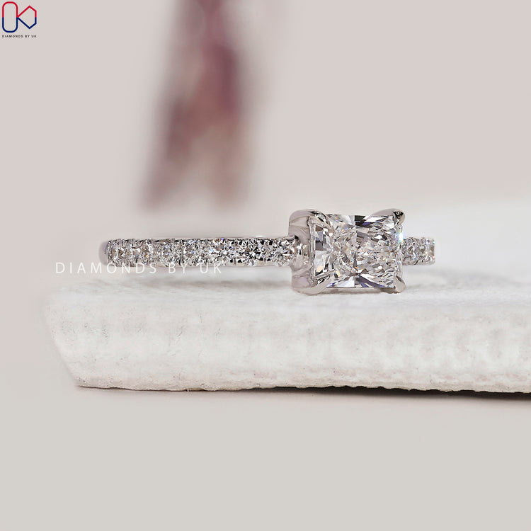 White gold engagement ring with claw prong setting and diamonds.
