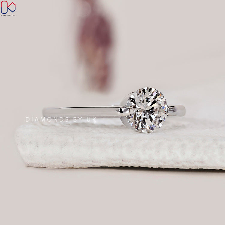 White gold engagement ring with a round solitaire diamond.
