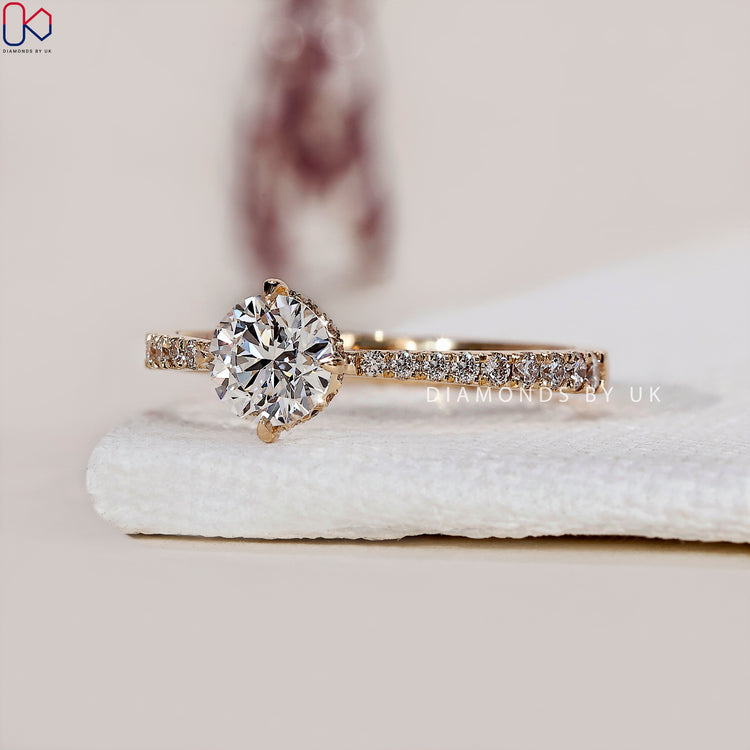4 prong claw setting holding a dazzling hidden halo engagement ring.
