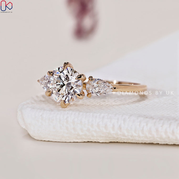 Exquisite handmade jewellery featuring a 3 stone diamond engagement ring with pear side stones.
