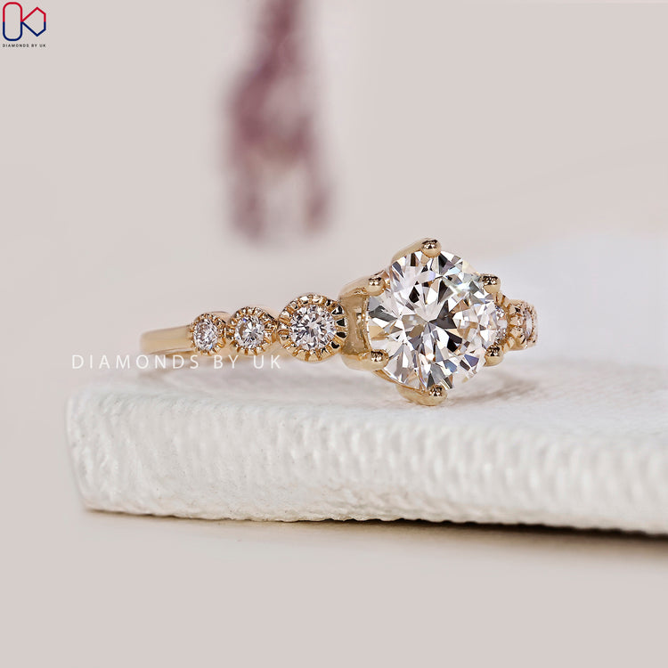 Yellow gold ring with a round diamond engagement setting.
