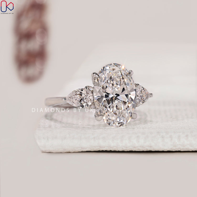 Prong setting ring with oval and pear cut diamonds.
