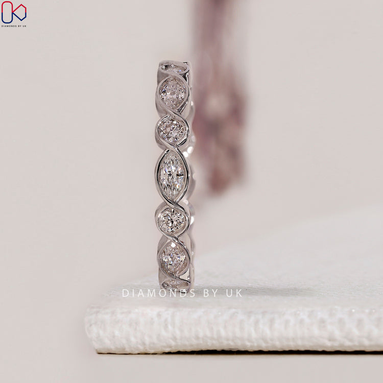 Classic white gold band with a delicate marquise design for your wedding.
