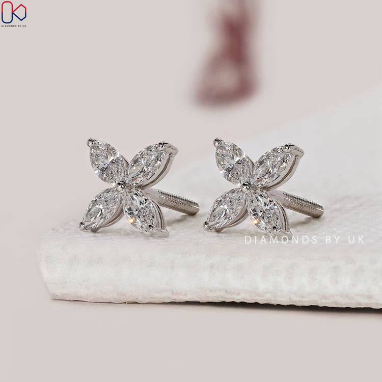 Push back earrings featuring custom marquise diamond designs.
