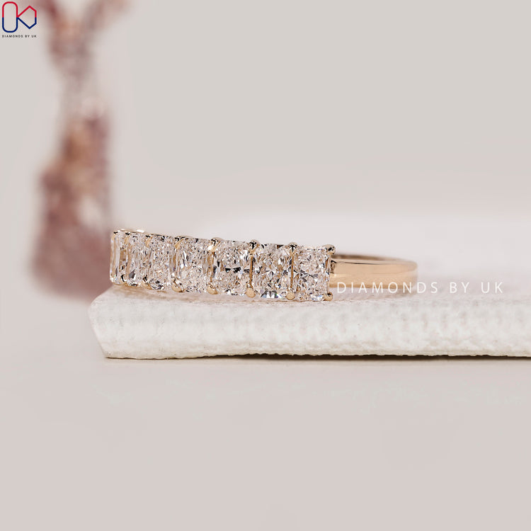 Prong setting band crafted with radiant cut diamonds in a custom design.
