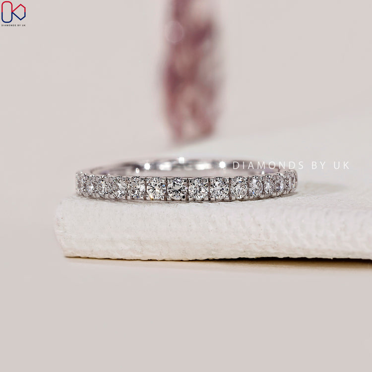 Minimalist wedding band with prong set lab diamonds.
