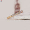 Yellow gold wedding band featuring a diamond half eternity design.
