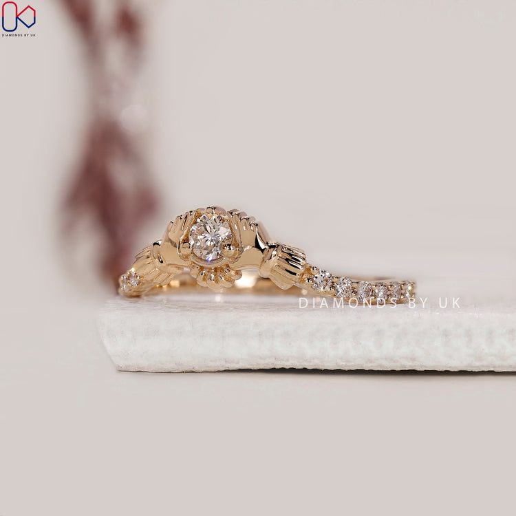 Prong set ring holding a round lab grown diamond at the centre of the Claddagh.