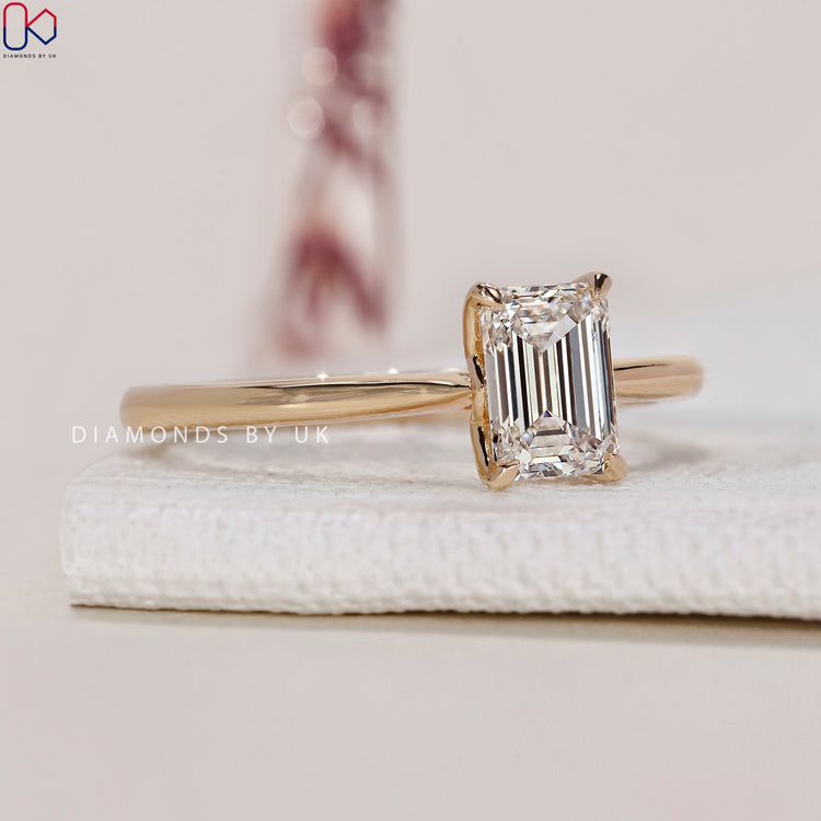 Tapered shank band enhances the beauty of this Emerald Cut Engagement Ring.
