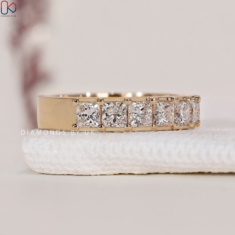 Shared prong band with princess cut diamonds for a secure, stunning design.

