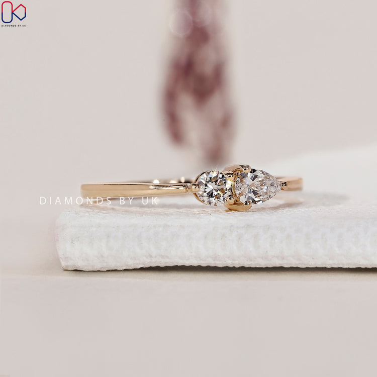 Handmade ring with round and pear diamonds for a unique style.
