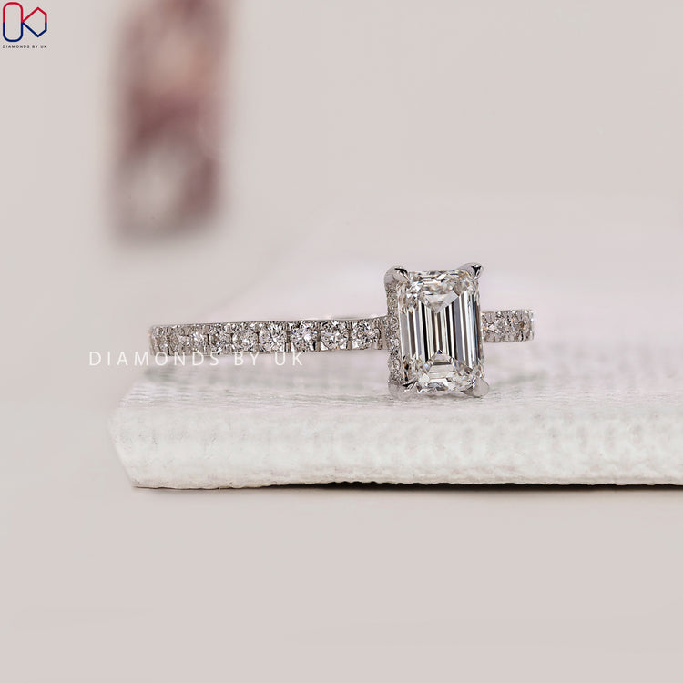 Emerald cut ring in cathedral setting

