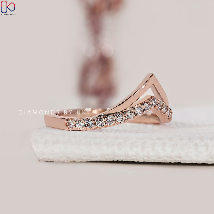 Prong set diamond band featuring a dainty and elegant design.
