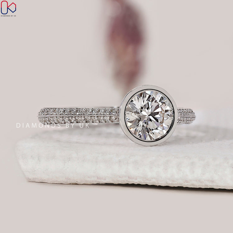 White gold ring with a Lab Grown Diamond and two sided pave setting.
