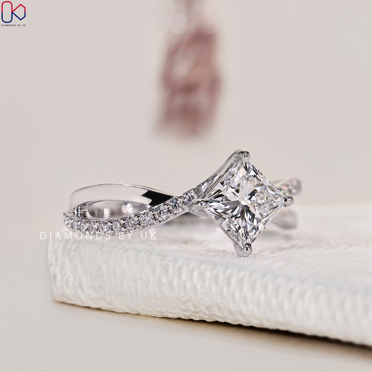 Round cut pave band ring in polished white gold.
