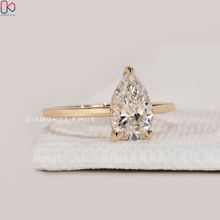 Yellow gold diamond ring with pear cut stone.
