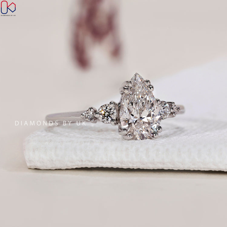 Pear Shaped Diamond Ring with Round Side Stones for a unique and elegant design.