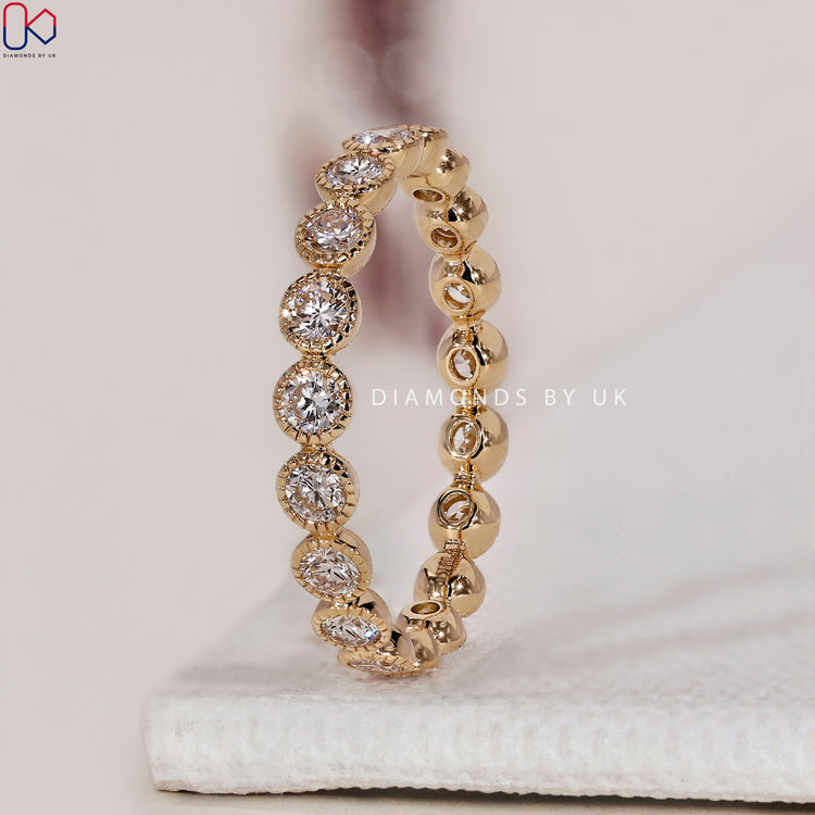 Yellow gold eternity band with diamonds for a timeless and elegant look.
