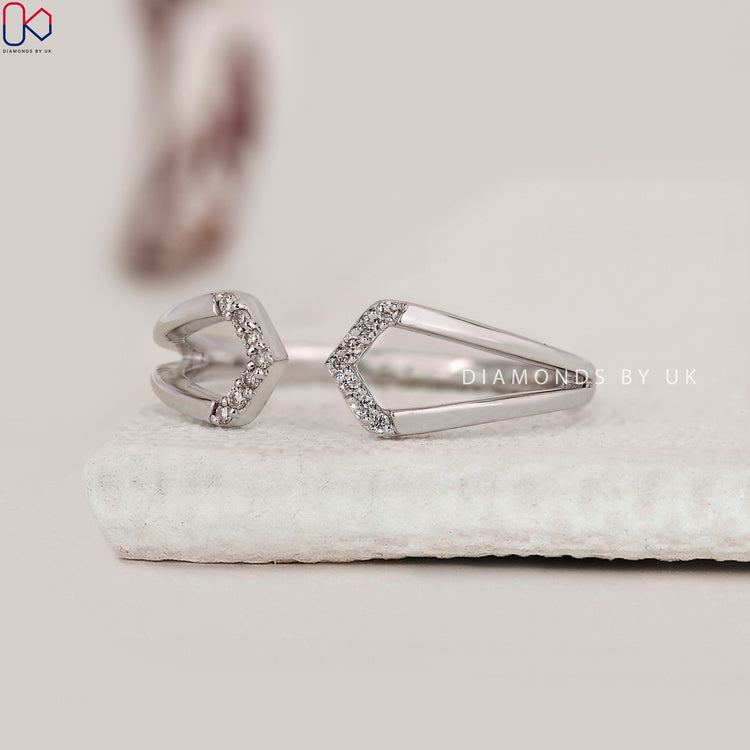 Round diamond ring in a modern open cuff style.
