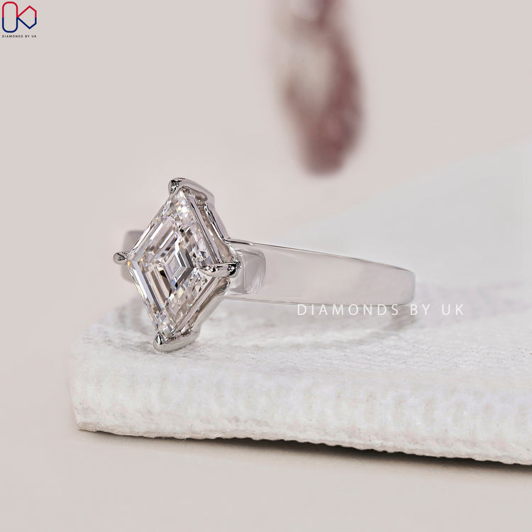 4 prong claw setting showcasing a beautiful lozenge cut diamond.