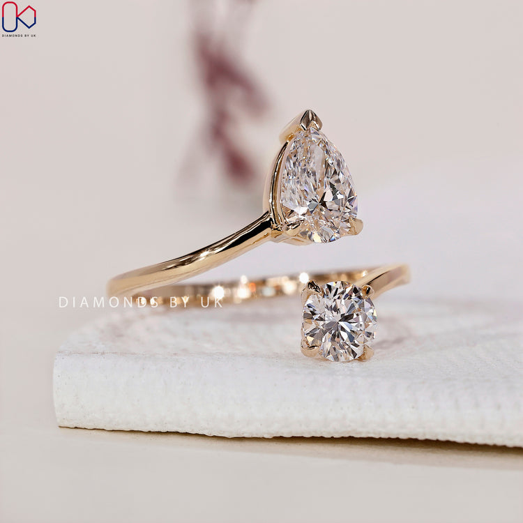 Two stone engagement ring with a pear cut and round diamond.